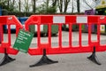 Red and white barrier stopping entry to a supermarket recycling facility