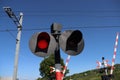 Red White barriers are coming down, bells ringing and red light at rail road crossing at Waddinxveen for R-NET train