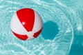 Red and white beach ball in a pool Royalty Free Stock Photo