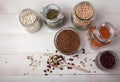 Red and white beans, peas, mung bean, red lentils, buckwheat in glass jars and a wooden spoon on a white wooden table. Top view Royalty Free Stock Photo