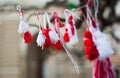 Red and white beautiful martisor balls closeup hanging on the branches of the tree