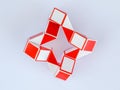 red white bicolor magic snake Transformable twist puzzle in shape of ninja star Royalty Free Stock Photo