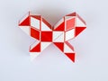 red and white bicolor magic snake twist puzzle in shape of bow Royalty Free Stock Photo