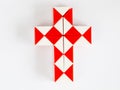 red and white bicolor magic snake twist puzzle in shape of cross isolated Royalty Free Stock Photo