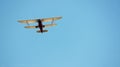 Red and White Biplane Flying in a Blue Sky Royalty Free Stock Photo