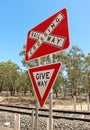 Red, white and black Railway Crossing and Give Way signs