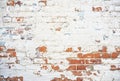 Terra cotta red brick wall white and blue peeling paint background Royalty Free Stock Photo