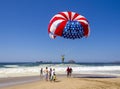 Red, white and blue of American flag parasail against bright blue sky. Royalty Free Stock Photo