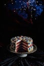 A red, white, and blue cake with a piece missing sits on a silver plate Royalty Free Stock Photo