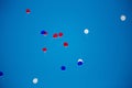 Red, white, blue helium balloons are flying into the blue sky Royalty Free Stock Photo