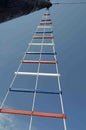 Red white and blue laddering on a sail boat on blue sky background Royalty Free Stock Photo