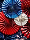 Red, white and blue patriotic theme with several paper fans. These fans are arranged in various sizes and shapes