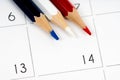 Red white blue pencils on calendar grid