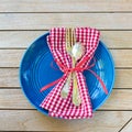 Red White and Blue Picnic Table Place Setting with napkin, fork, spoon and plate. Square and flat layout style photo taken outsid Royalty Free Stock Photo