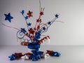 Red, white and blue top hat with stars and ribbons on top and glitter stars lined up along it on a white background for Memorial Royalty Free Stock Photo