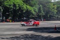 Red and White BMW 325i E46 drift car slides in practice session in Indonesia drift series event