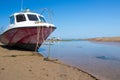 Red and white boat moored by a river Royalty Free Stock Photo