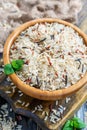 Red, white, brown and wild rice in a wooden bowl closeup. Royalty Free Stock Photo