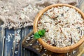 Red, white, brown and wild rice in a wooden bowl closeup. Royalty Free Stock Photo
