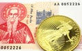 A red and white Bulgarian one lev note with a gold coin in macro