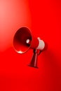 Red and white bullhorn on red wall with red background. Generative AI