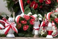 Red and white candles and flowers in the colors of the Polish flag, national anniversary in Poland. Polish national colors