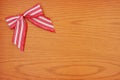 Red and white candy cane bow Christmas background with wood Royalty Free Stock Photo