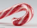 A red and white candy cane, lying on its side against a light gray background, with striped segments and a glossy texture - AI Royalty Free Stock Photo