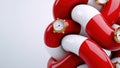Red and white capsule-shaped objects interlock, featuring small gold gauges as design elements, creating an abstract, kinetic Royalty Free Stock Photo