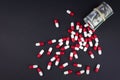 Red white capsules spill out of folded dollars Royalty Free Stock Photo