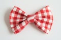 A red and white checkered bow tie on a light background Royalty Free Stock Photo