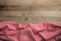 Red white checkered picnic tablecloth on wooden background, copy space Royalty Free Stock Photo