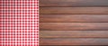 Red white checkered picnic tablecloth on wooden table, copy space. 3d illustration Royalty Free Stock Photo