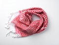 Red white checkered scarf w tassels draped on white background Royalty Free Stock Photo