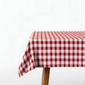 Red and white checkered tablecloth draped over a wooden table corner on white Royalty Free Stock Photo