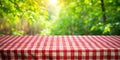 Red and white checkered tablecloth on a table with a blurred green background. Generative AI Royalty Free Stock Photo