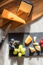 Red and white cheese flat lay food image with grapes