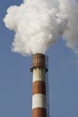 Red-white chimney with heavy smoke