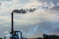 Red and White Chimney Smoking on Cloudy Sky Background