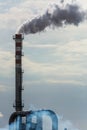 Red and White Chimney Smoking on Cloudy Sky Background