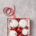 Red and white Christmas baubkes in a box