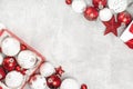 Red and white Christmas baubles in a box on gray Royalty Free Stock Photo