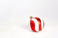 Red White Christmas Decoration Bauble on white snow background. Royalty Free Stock Photo