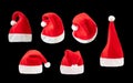 Red and white christmas hat set on black background. Santa claus cap from different angles on the plain dark background Royalty Free Stock Photo