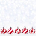 Red and white Christmas ornaments in snow with twinkling background Royalty Free Stock Photo