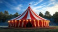 Red and white circus tent in a green field with blue sky Royalty Free Stock Photo