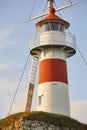 Red and white classic lighthouse. Faroe islands, Torshavn harbor