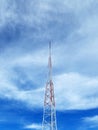 Red and White Communication tower against a cloudy sky Royalty Free Stock Photo