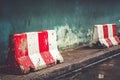 Red white concret barrier stop going sign on street stand on footpath green painted old wall background