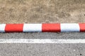 Red and white concrete sidewalk signs on a road. Footpath road.